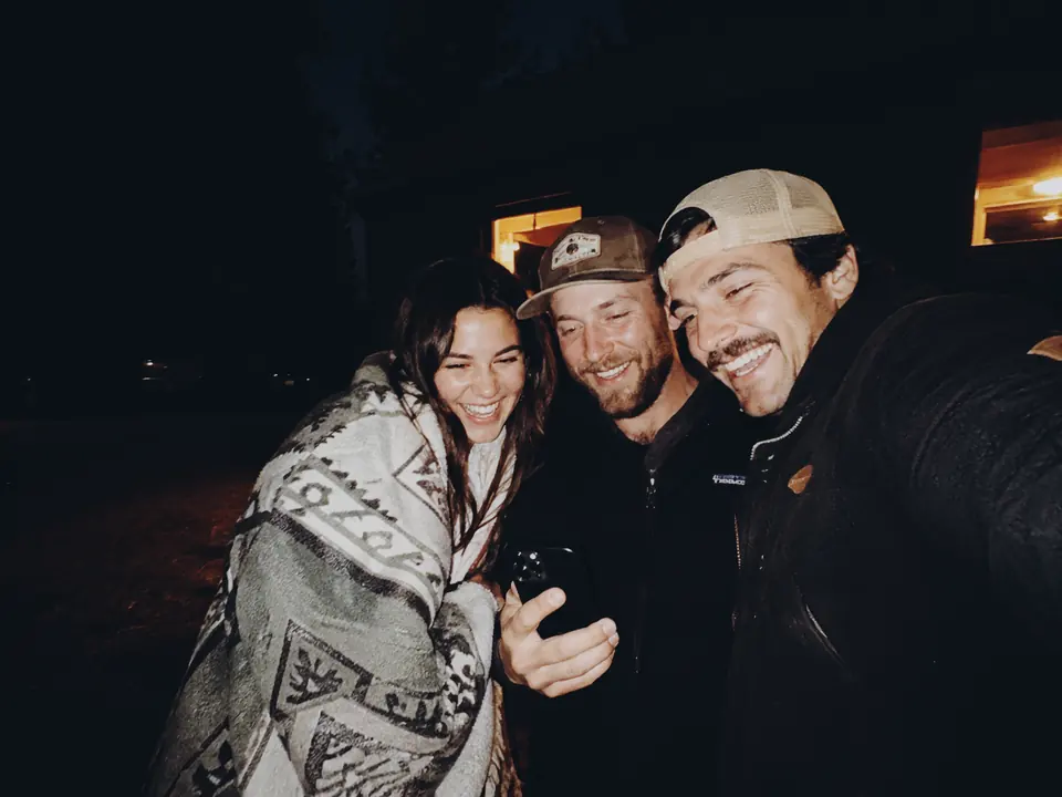 Three friends smiling together
